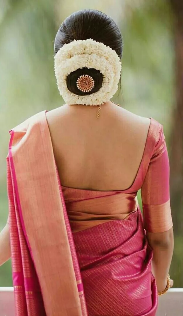Neat Bun with a Circular Ring of Gajra Wedding Hairstyle for Saree