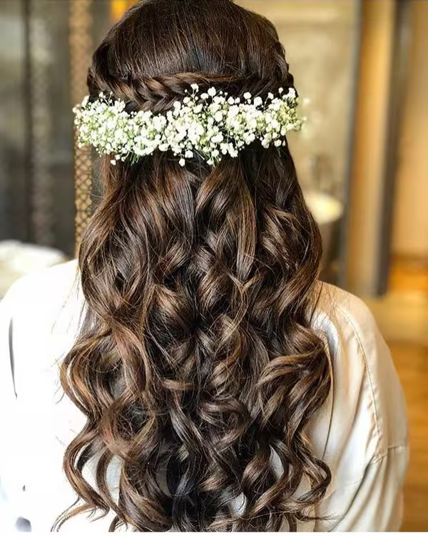 Open Curls with Floral Adornments Wedding Hairstyle for Saree