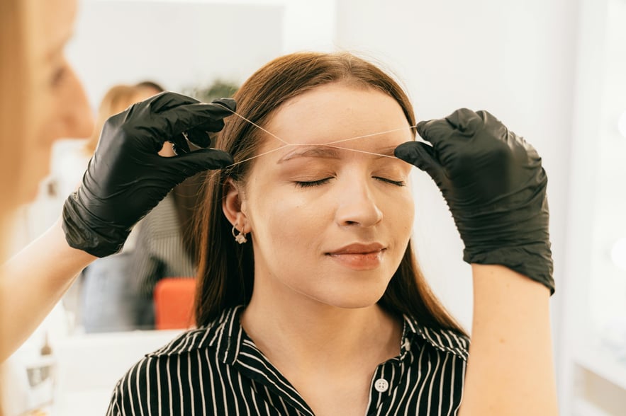 Eyebrow threading in salon