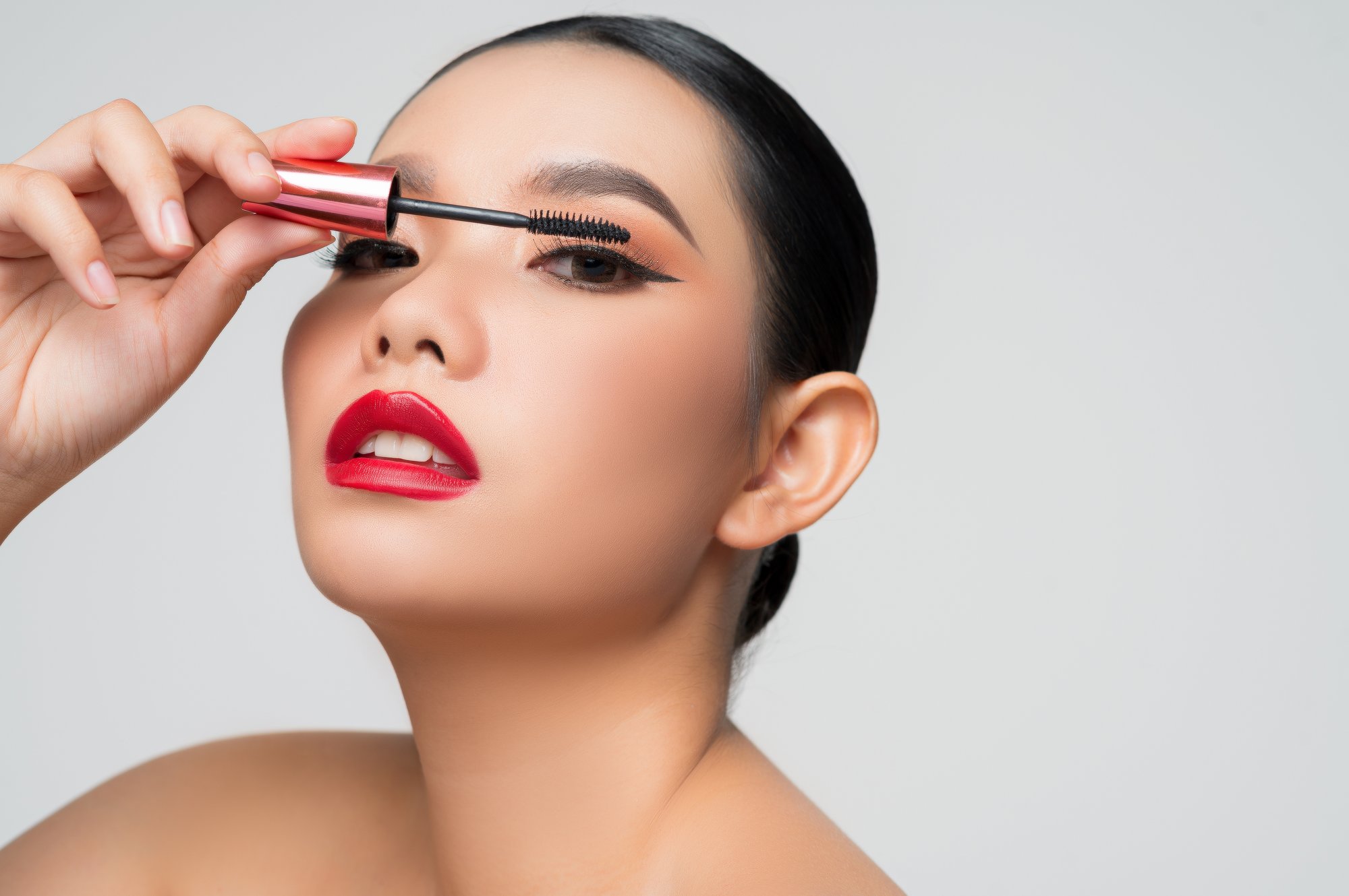 portrait-beautiful-asian-woman-with-mascara-hand