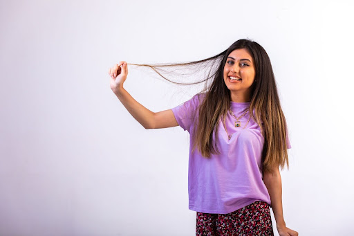 Smiling woman holding her hair