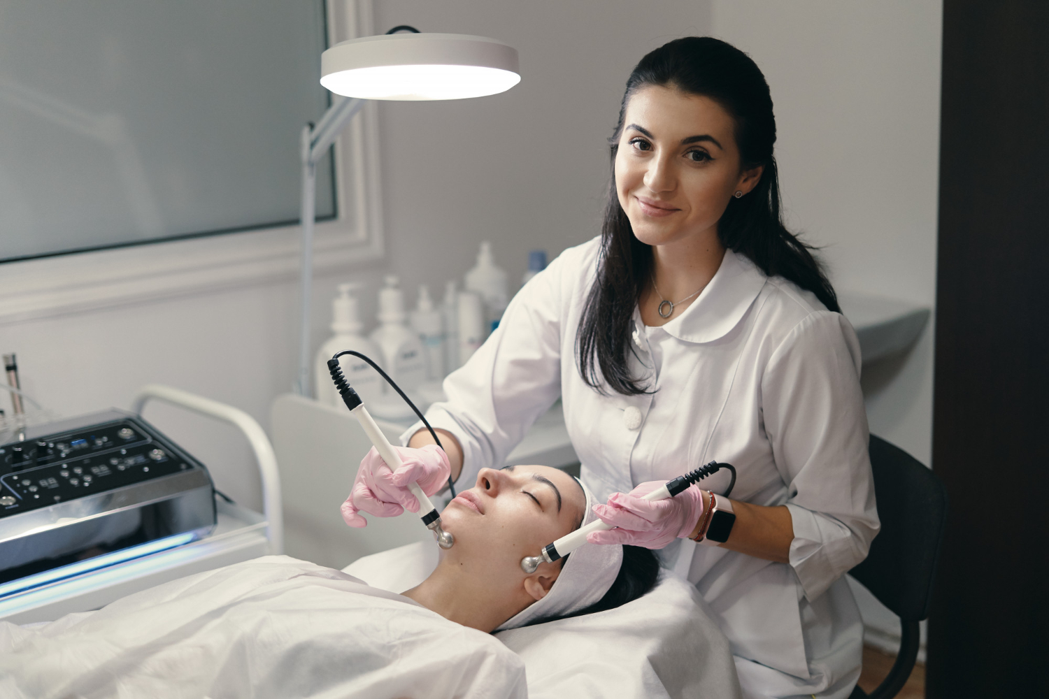 A lady doctor treating another lady for skin whitening