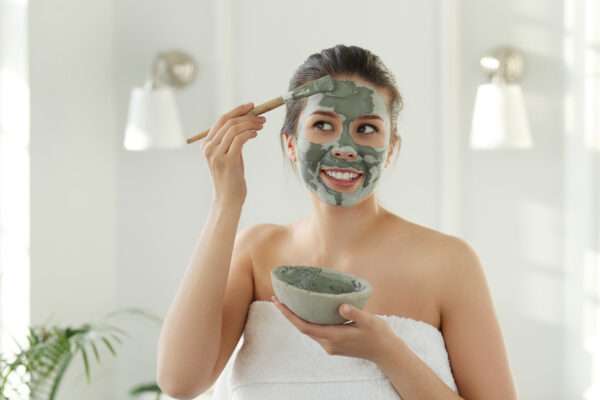 applying clay mask for open pores on face